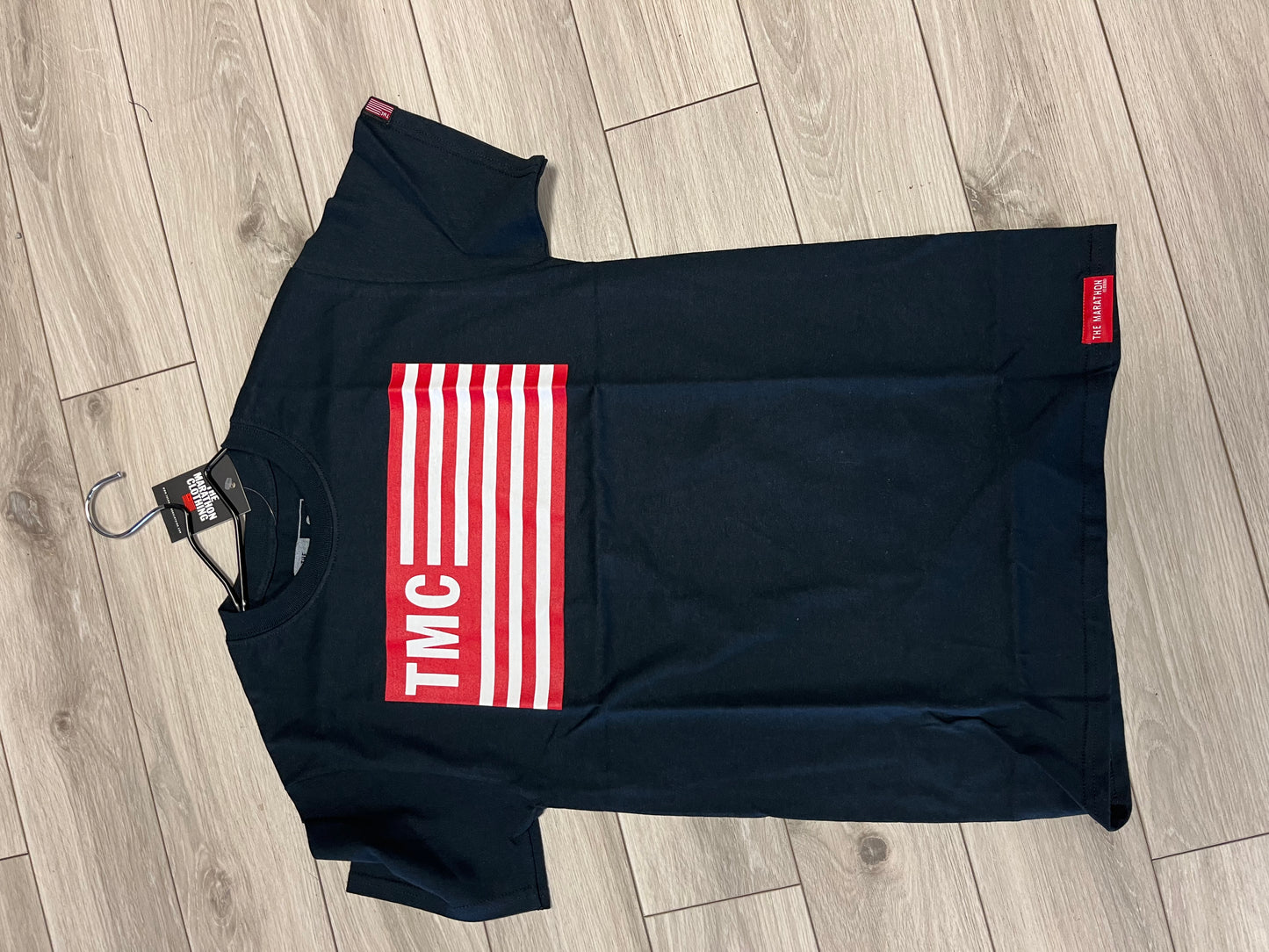 'THE MARATHON' TMC FLAG TEE BLACK